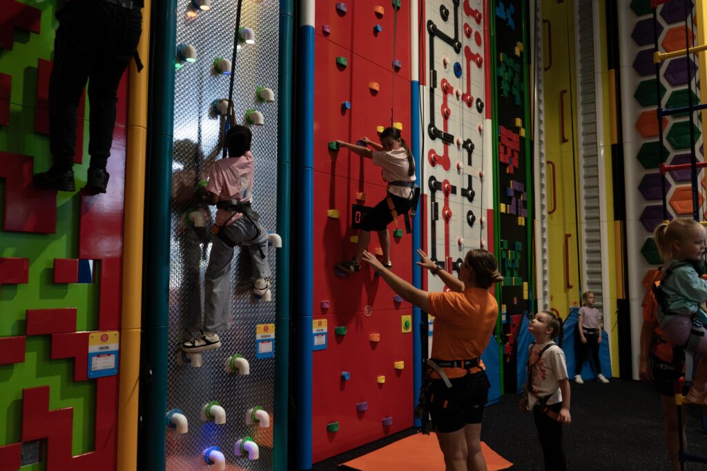 Children take on the climbing wall challenges at Climb Up Doncaster